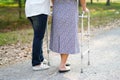 Help and care Asian senior or elderly old lady woman use walker with strong health while walking at park Royalty Free Stock Photo