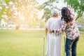 Help and care Asian senior or elderly old lady woman use walker with strong health while walking at park Royalty Free Stock Photo