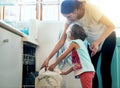 Help, dishwasher and mom with girl in home for chores, teaching or learning hygiene routine. Housekeeping, mother and Royalty Free Stock Photo