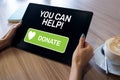 Help and donation button on device screen. Royalty Free Stock Photo