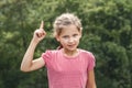 Help Earth. Environmental Protection. Earth Day. Little girl pointing fingers up Royalty Free Stock Photo