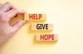 Help give hope symbol. Concept word Help give hope on beautiful wooden block. Businessman hand. Beautiful white table white Royalty Free Stock Photo