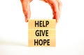 Help give hope symbol. Concept word Help give hope on beautiful wooden block. Businessman hand. Beautiful white table white Royalty Free Stock Photo