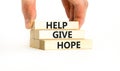 Help give hope symbol. Concept word Help give hope on beautiful wooden block. Businessman hand. Beautiful white table white Royalty Free Stock Photo