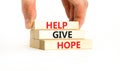 Help give hope symbol. Concept word Help give hope on beautiful wooden block. Businessman hand. Beautiful white table white Royalty Free Stock Photo