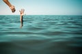 Help hand for drowning man life saving in sea or ocean. Royalty Free Stock Photo