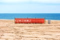 Help keep your beach clean banner on the sand of Brighton Beach. Calm blue water of Atlantic ocean on horizon - Brooklyn, New York