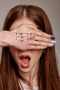 Help me Psychological portrait of woman`s cries for help with painted inscription on her hand. Fear, pain, depression