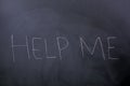 Help me word written on a blackboard