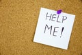 Help me written on a sticky note pinned on a cork board Royalty Free Stock Photo