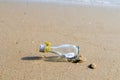 `HELP` message in glass bottle on the beach Royalty Free Stock Photo