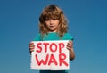 Help now and Ukrainian flag. Protest against war in Ukraine. Child holding sign with words Stop war standing outdoors. Royalty Free Stock Photo