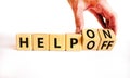 Help on or off symbol. Businessman turns wooden cubes and changes word Help off to Help on. Beautiful white table white background Royalty Free Stock Photo