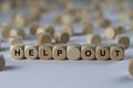 Help out - cube with letters, sign with wooden cubes Royalty Free Stock Photo