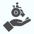 Help for people with disabilities solid icon. Disabled carriage vector illustration isolated on white. A hand holding a