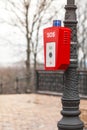 Help or police call button. SOS. A stand with a button is fixed on the street, on a lamppost Royalty Free Stock Photo