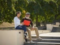 Portrait of young girl sitting with grandfather at park