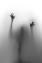 Help ! Spooky spirit, hands and fingers, and blurry body silhouette behind a textile curtain. Royalty Free Stock Photo