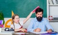 Help study. Study is fun. School teacher and schoolgirl. Homeschooling with father. Man bearded pedagogue study together