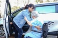 Help and support asian senior or elderly old lady woman patient sitting on wheelchair prepare get to her car