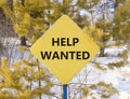 Help wanted and support symbol. Concept words Help wanted on beautiful yellow road sign. Beautiful forest snow blue sky background Royalty Free Stock Photo
