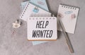 HELP WANTED text written on a sticky on grey background. Royalty Free Stock Photo