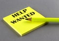 HELP WANTED text written on a sticky on grey background Royalty Free Stock Photo