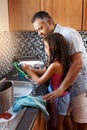 Help, washing dishes and a father with a child in the kitchen for teamwork, cleaning and chores. House, helping and a Royalty Free Stock Photo