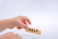 Help word on a piece paper  in hand Royalty Free Stock Photo