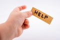 Help word on a piece paper  in hand Royalty Free Stock Photo