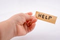 Help word on a piece paper  in hand Royalty Free Stock Photo