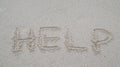 Help word writing on the sand at the beach as a relevant concept to your need Royalty Free Stock Photo