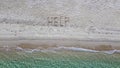 Help written on exotic sand beach with tropic blue sea.