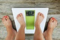 Help your child to have a healthy diet and lifestyle, with obese kid feet on weight scale, under the supervision of the mother Royalty Free Stock Photo