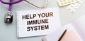 Help your immune system write on a medical notebook. Background on the table with a stethoscope and pills. medicine and health