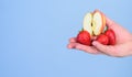 Help yourself. Fresh harvest of ripe fruit berries. Hand proposes take strawberry and apple fruit. Male hand with