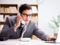 Helpdesk operator talking on phone in office Royalty Free Stock Photo