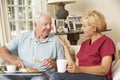 Helper Serving Senior Man With Meal In Care Home Royalty Free Stock Photo
