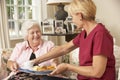 Helper Serving Senior Woman With Meal In Care Home Royalty Free Stock Photo