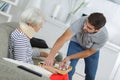 Helper serving senior woman with meal in care home Royalty Free Stock Photo