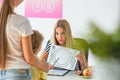 Dietitian holding the chock, preparing healthy diet plan for her patients