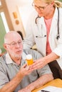 Helpful Doctor or Nurse Explaining Prescription Medicine to Attentive Senior Man Royalty Free Stock Photo