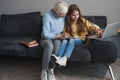 Caring grandma helping a little girl with her homework