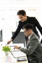 Helpful male boss mentor coach teacher explaining new online project to young male worker intern student, focused leader executive Royalty Free Stock Photo