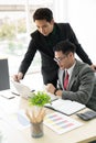 Helpful male boss mentor coach teacher explaining new online project to young male worker intern student, focused leader executive Royalty Free Stock Photo