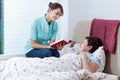 Helpful nurse reading book Royalty Free Stock Photo