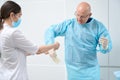 Helpful nurse slipping on latex gloves on doctor hands Royalty Free Stock Photo