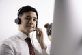 Helpful operator dispatcher wearing headset assisting customers in customer support service taking phone calls at office Royalty Free Stock Photo