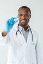 Joyful afro american doctor holding a vitamin pill