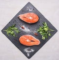 Helpful sports foods, cooking two fresh salmon steak with herbs , spices, top view Royalty Free Stock Photo
